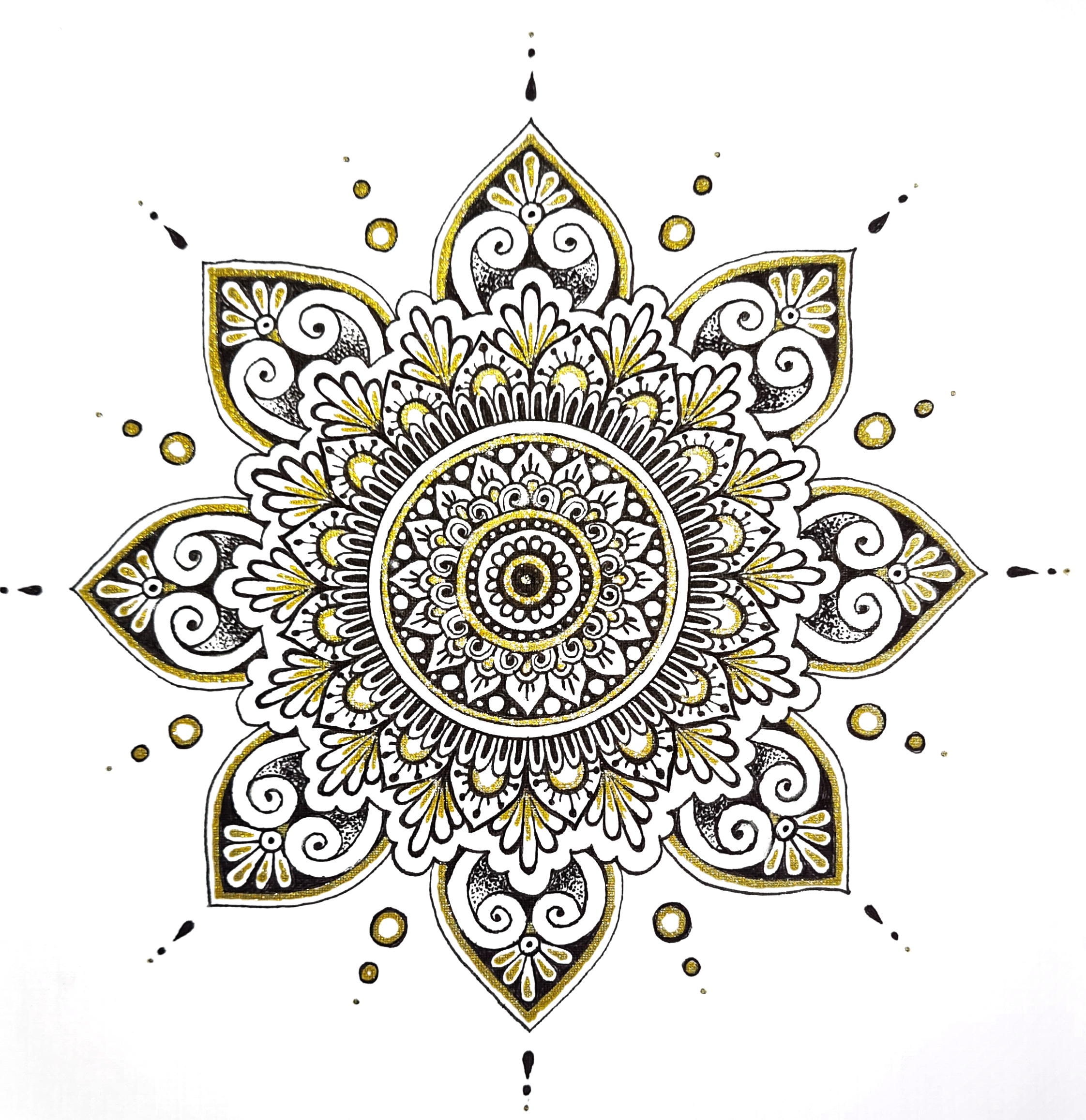 A mandala being drawn by hand using a compass and pen
