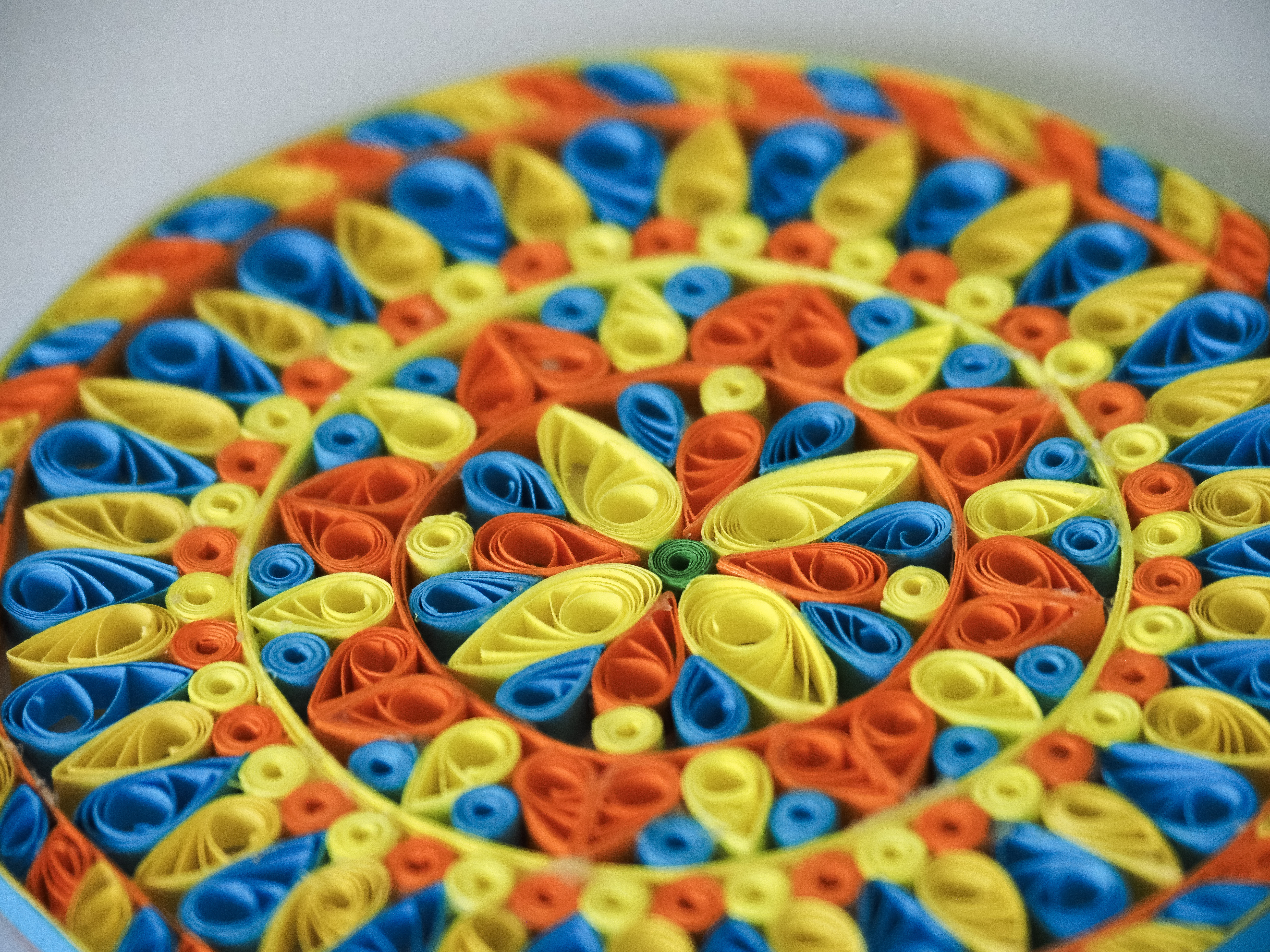 Paper quilling shapes and coils laid out ready for a workshop
